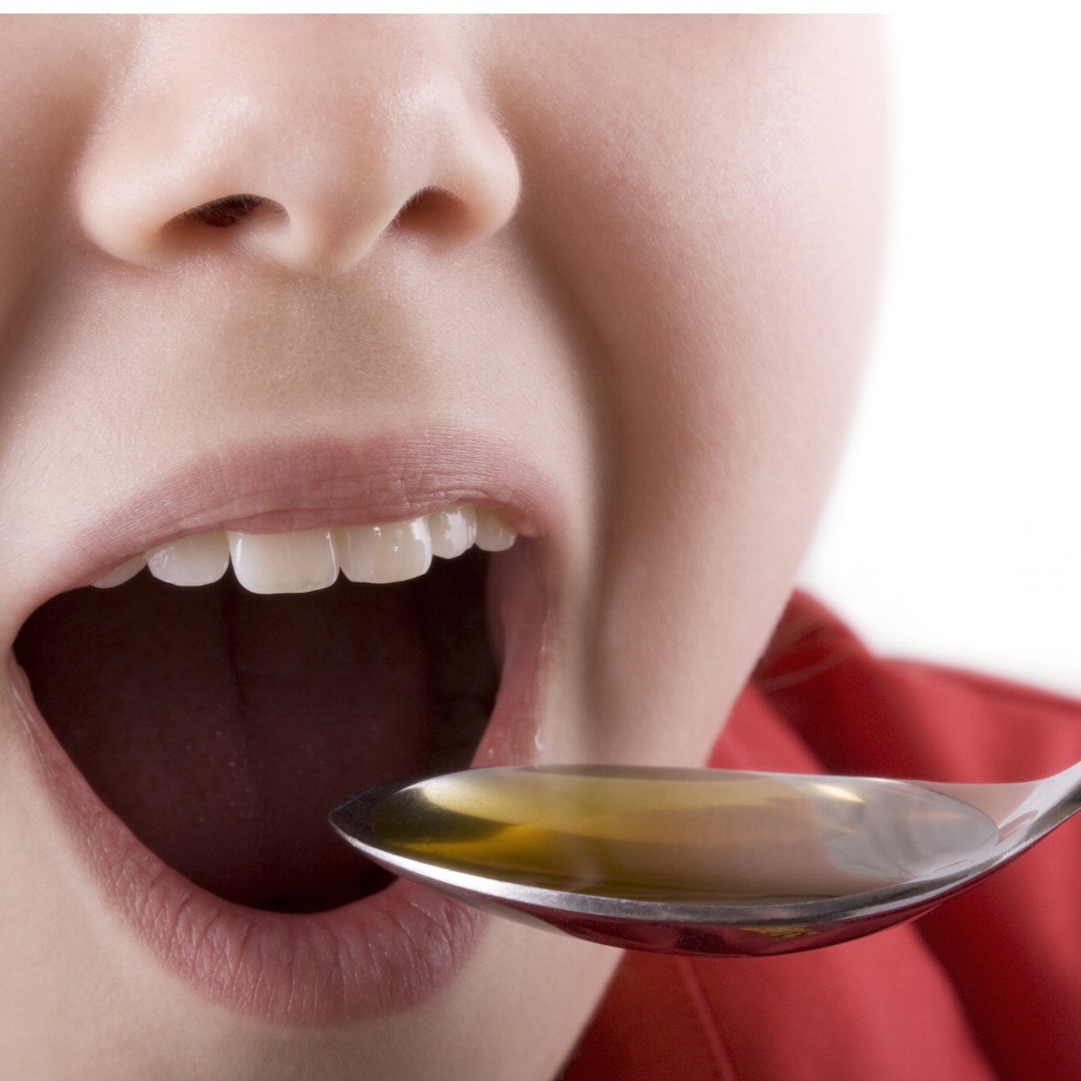 Image of child taking a spoonful of cod liver oil.